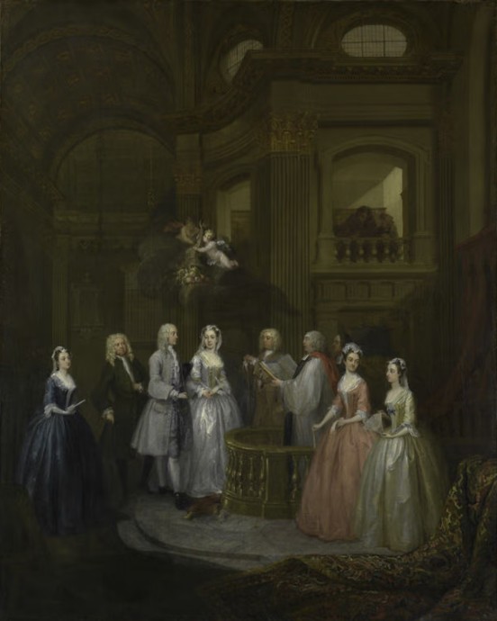 a well dressed couple seated in an ornate room a well dressed couple seated in an ornate room
